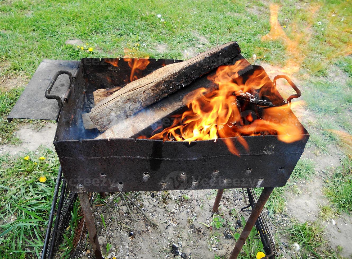 dark grey black coals inside metal brazier photo