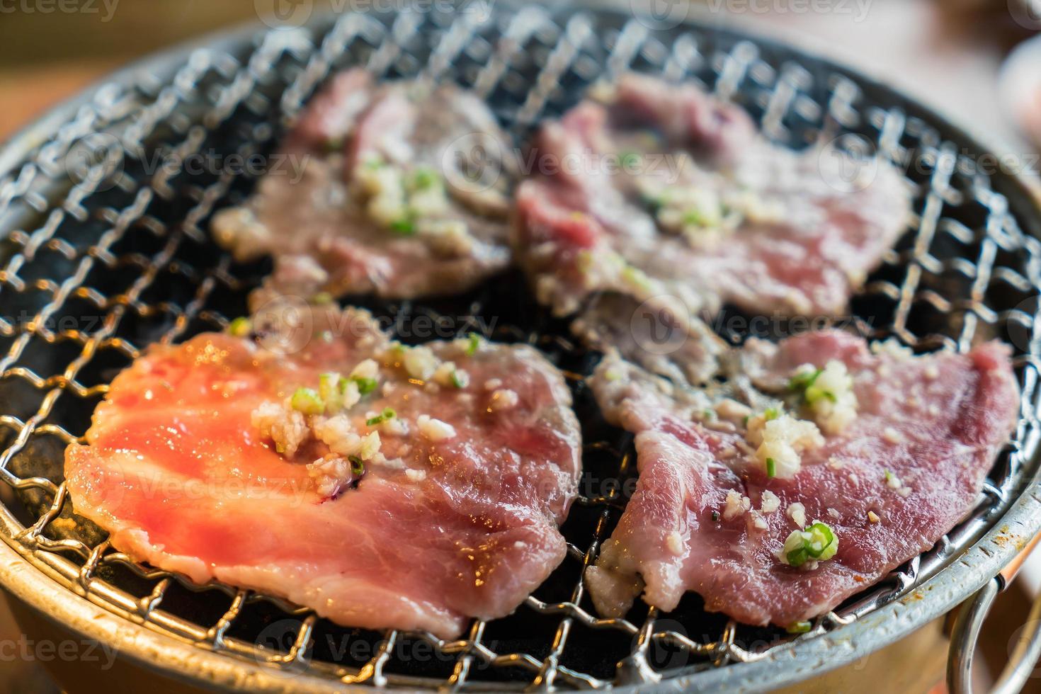 Pork on charcoal grill - Yakiniku - Korean style photo