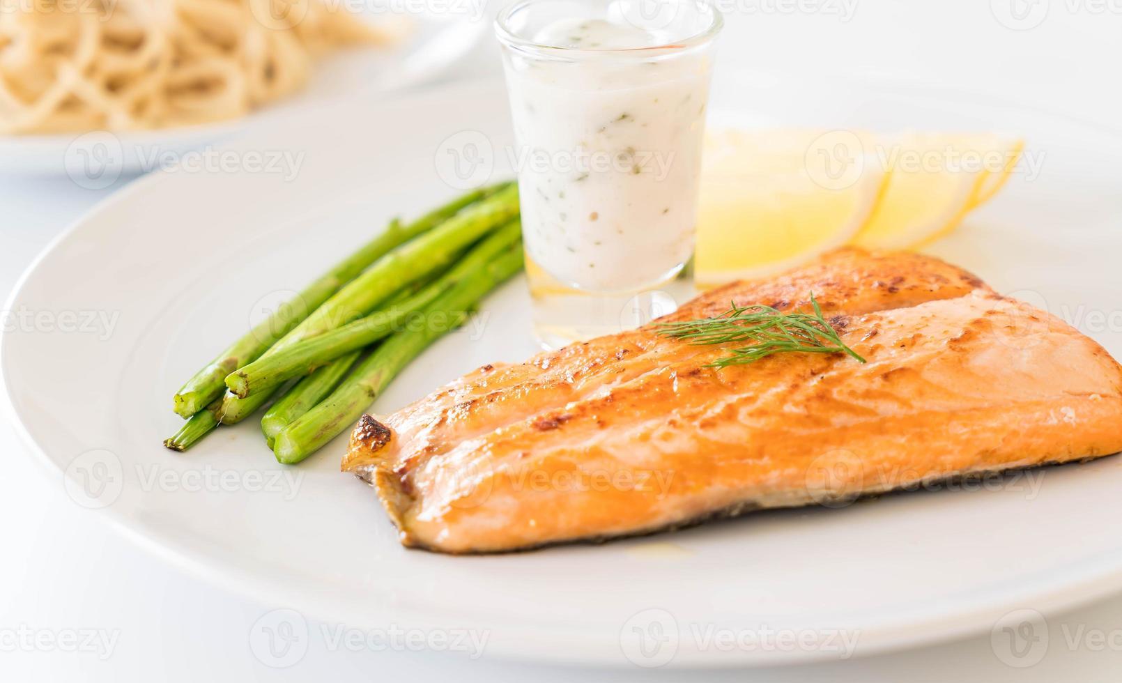 Filete de salmón a la plancha sobre la mesa foto