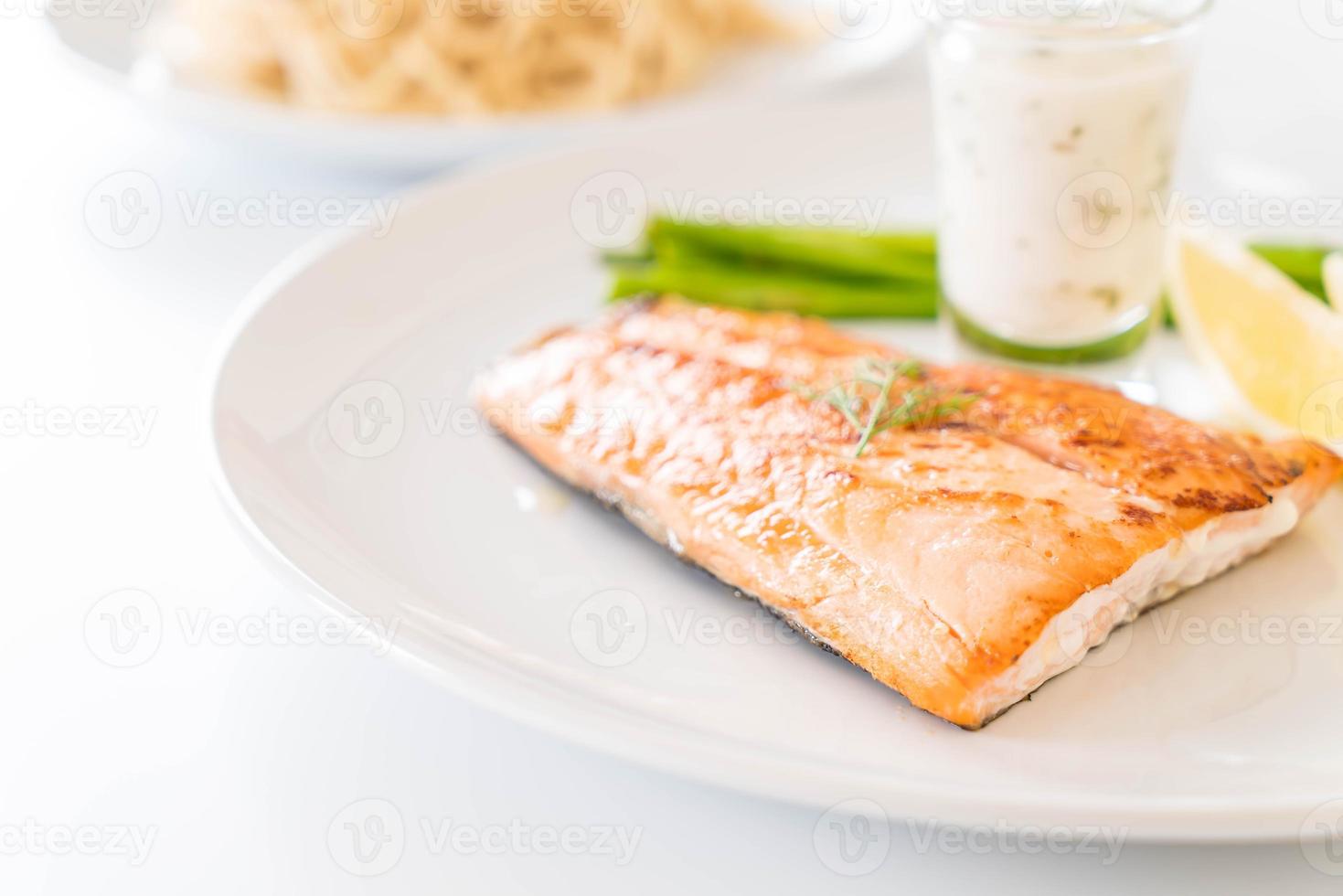 Grilled salmon steak on the table photo