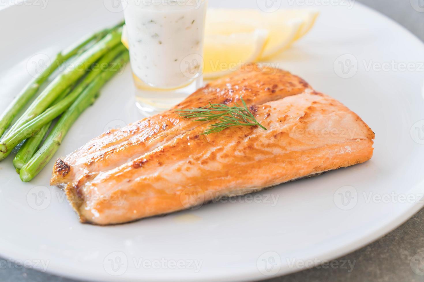 Grilled salmon steak on the table photo