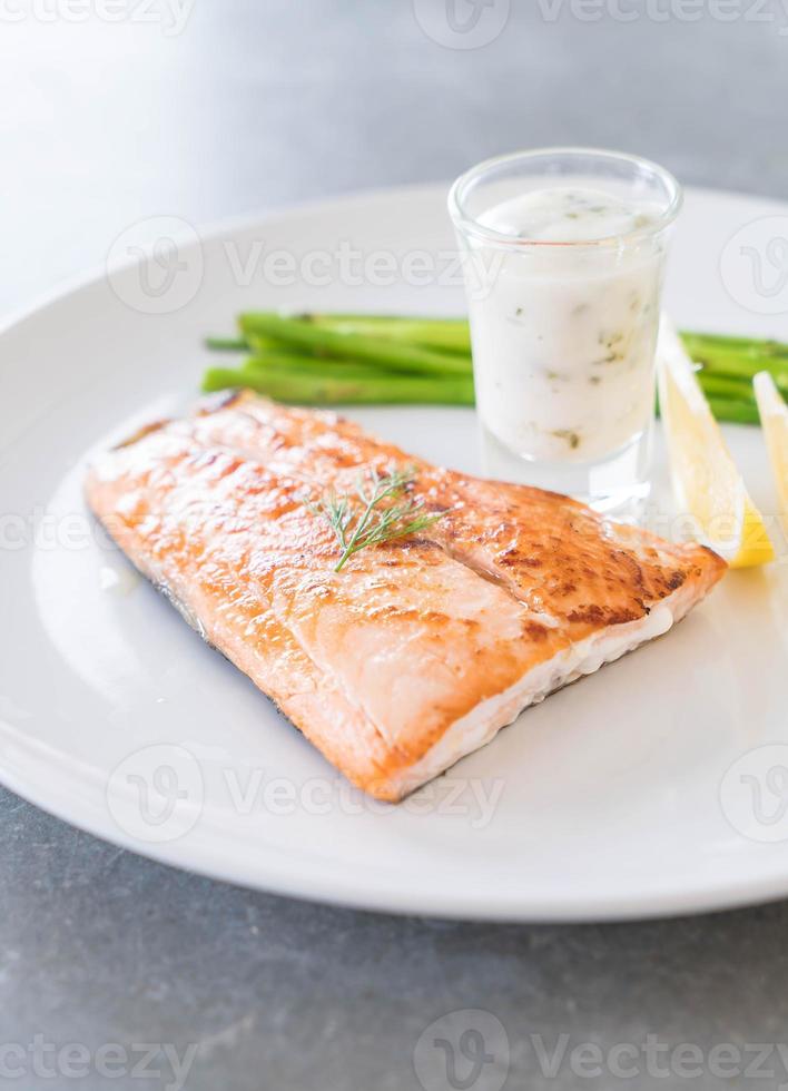 Grilled salmon steak on the table photo