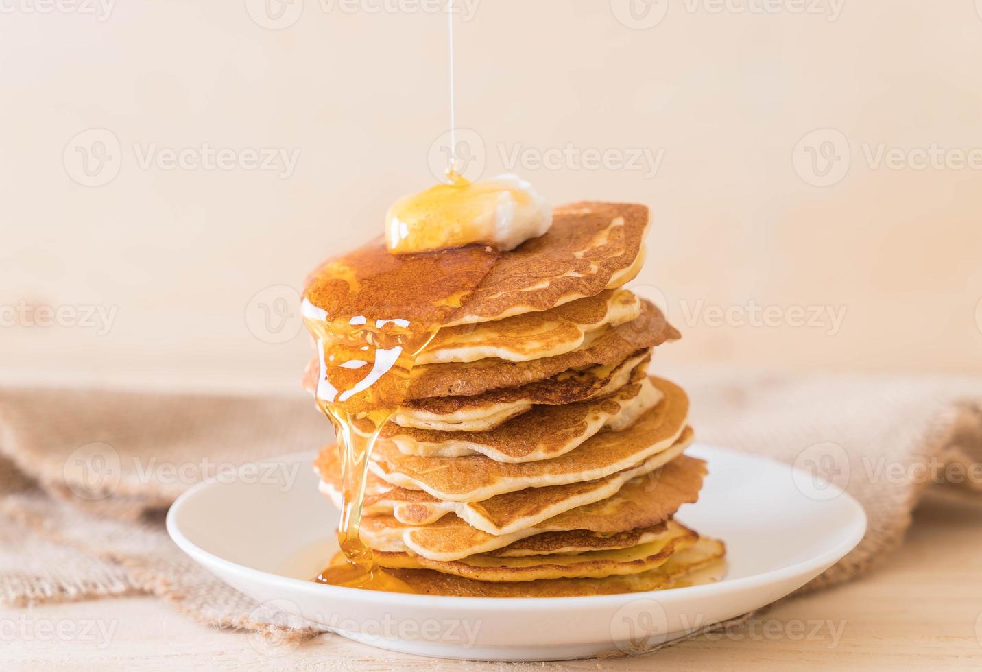 Cheese on pancake stack with honey photo