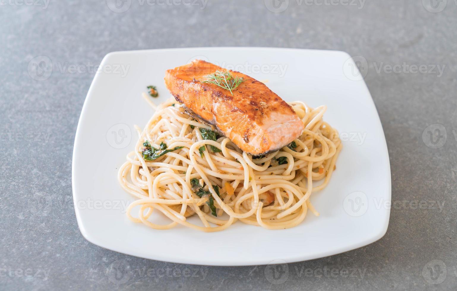 Stir-fried spicy spaghetti with grilled salmon photo