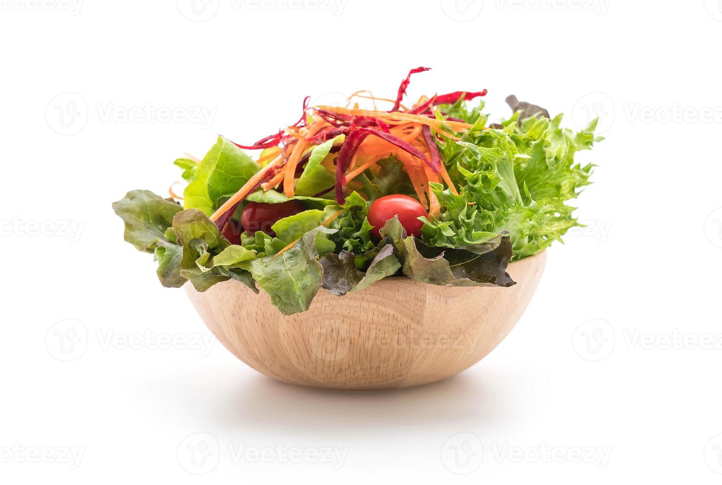 Mixed salad in wood bowl on white background photo