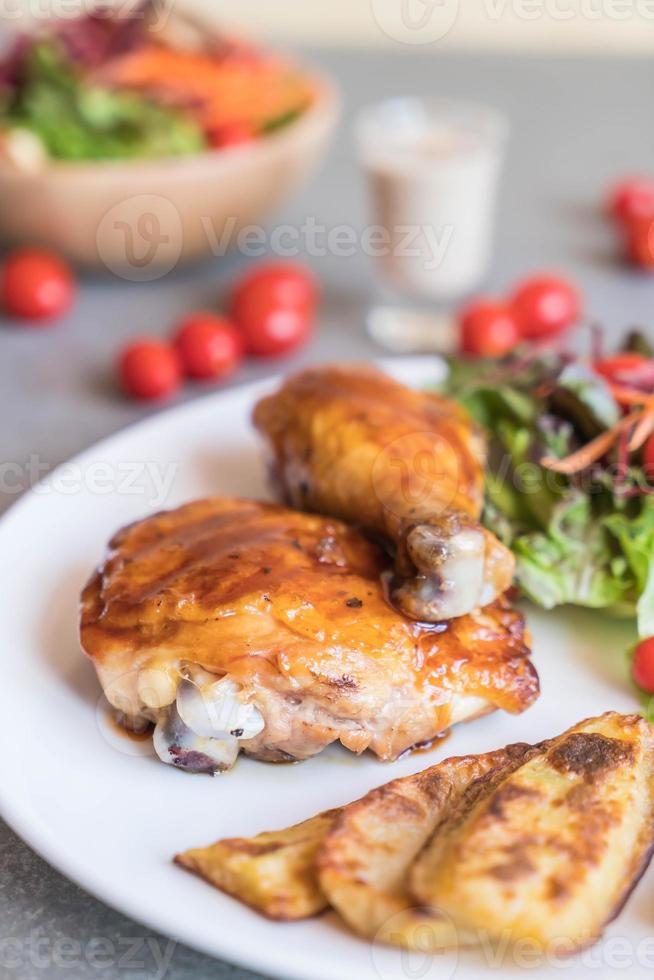 Grilled chicken steak with teriyaki sauce on dining table photo