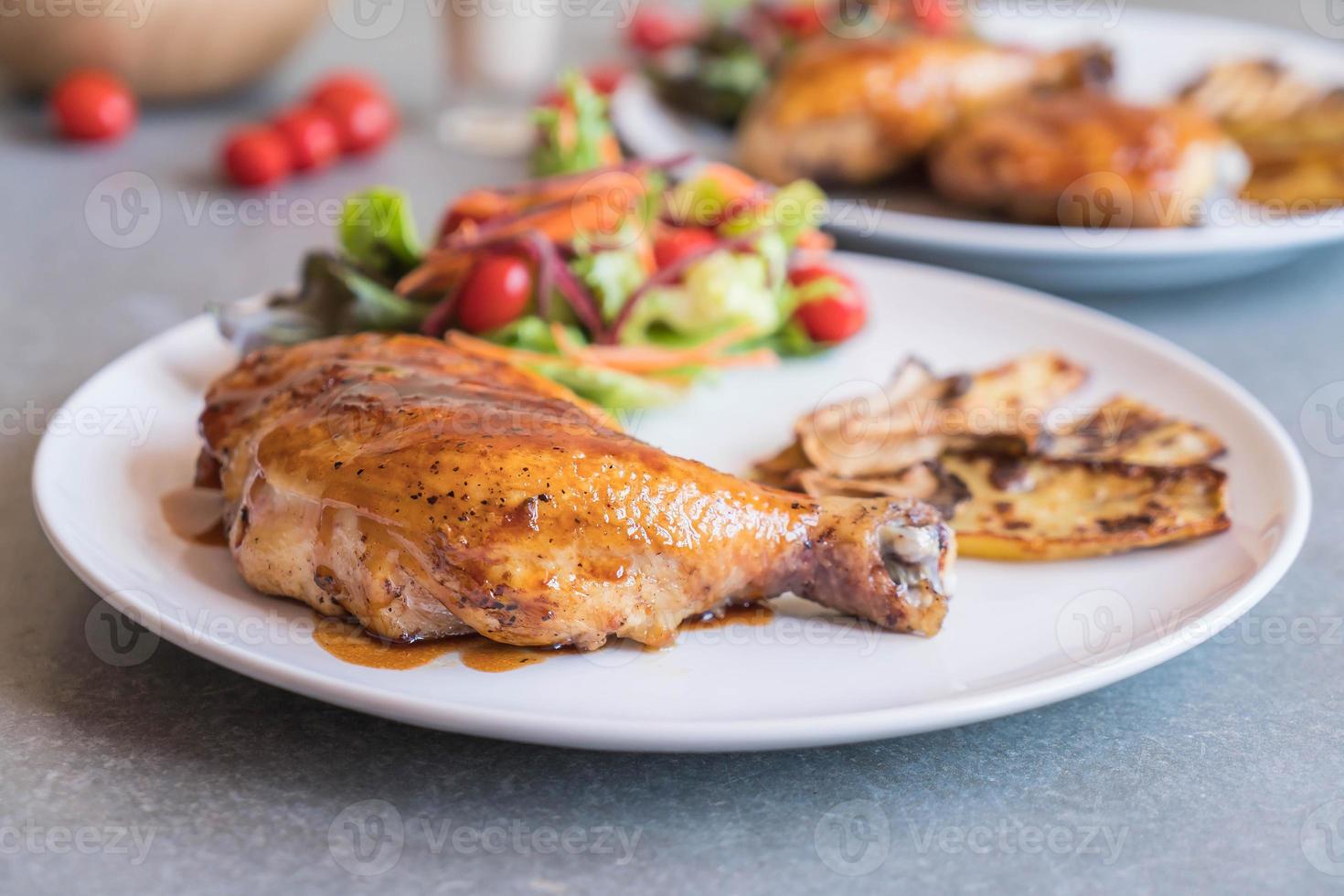 Grilled chicken steak with teriyaki sauce on dining table photo