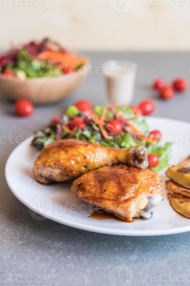 Grilled chicken steak with teriyaki sauce on dining table photo