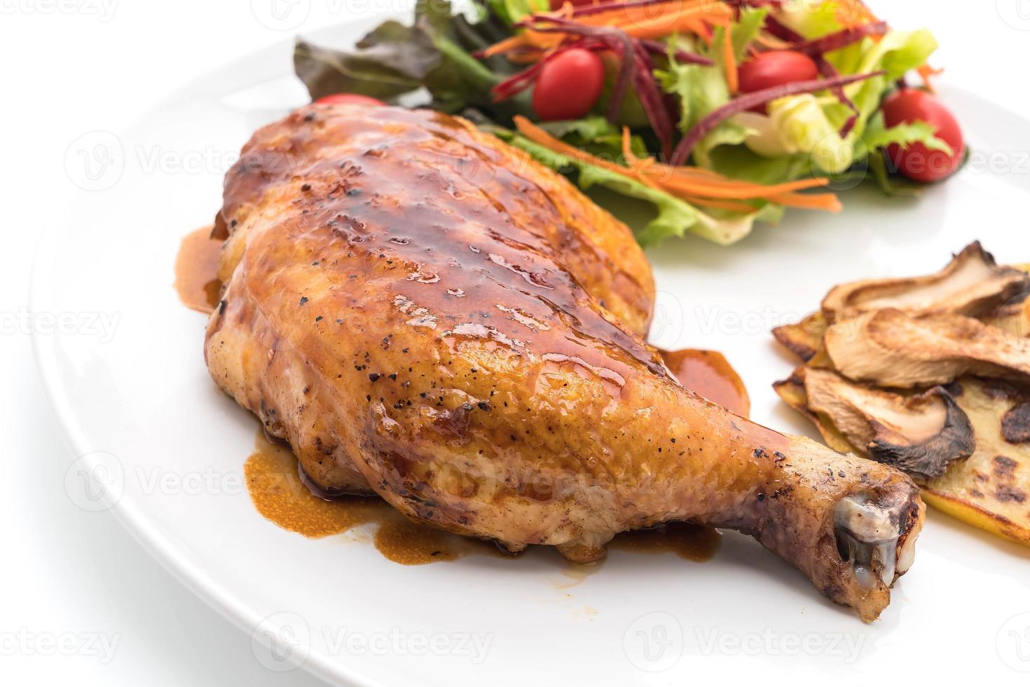 Grilled chicken steak with teriyaki sauce on dining table photo