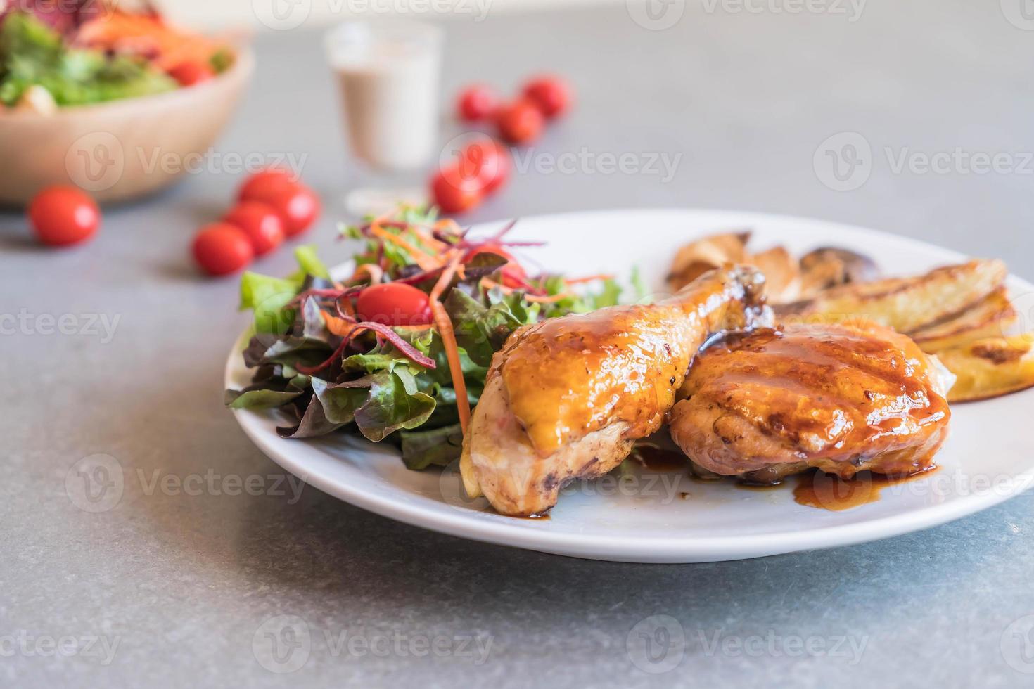 Grilled chicken steak with teriyaki sauce on dining table photo