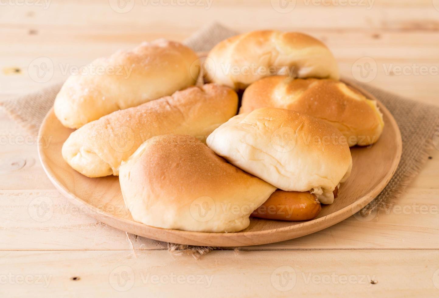 Bread in wood plate on the table photo