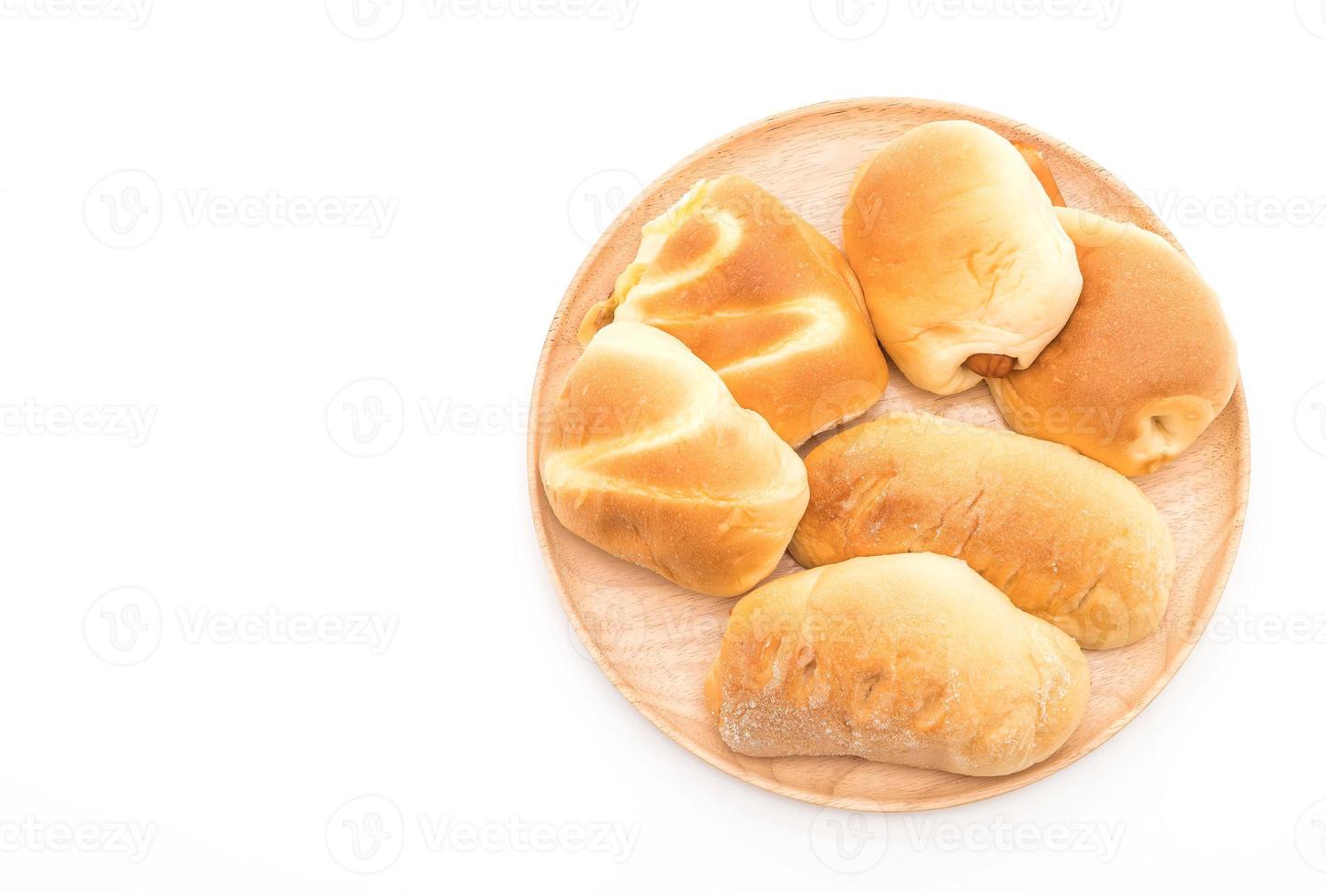 Bread in wood plate on white background photo