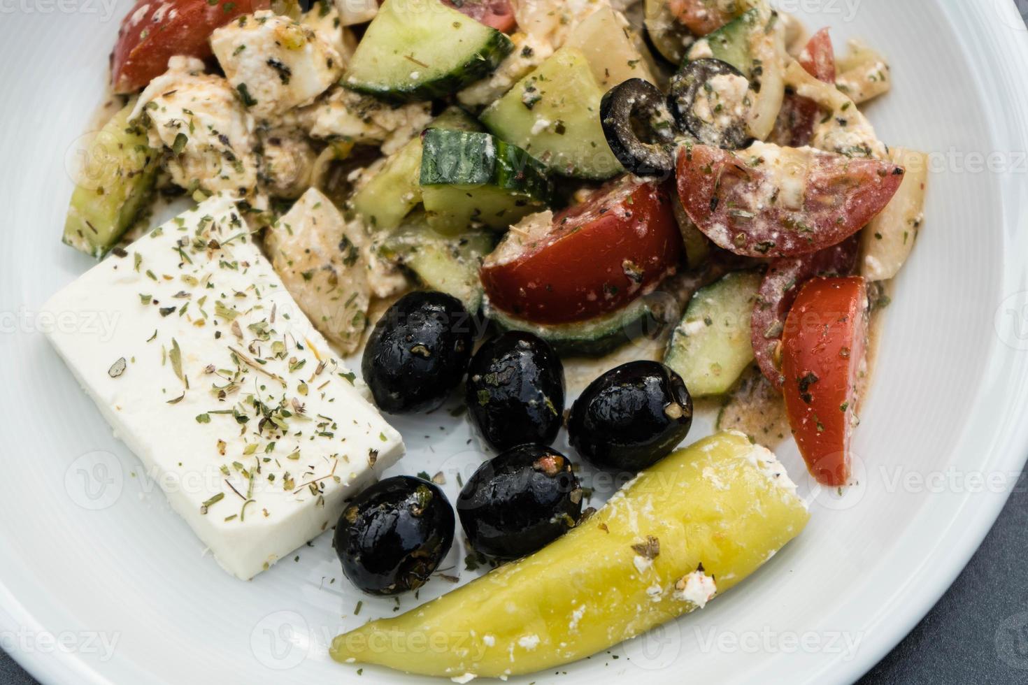 Greek salad with feta cheese olives and hot peppers photo