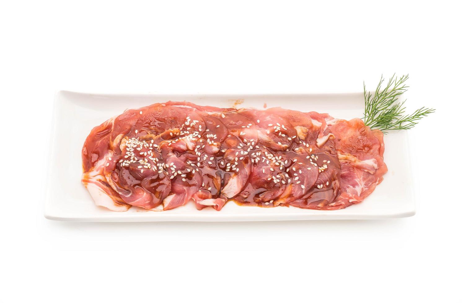 Fresh pork sliced with sauce and sesame on white background photo