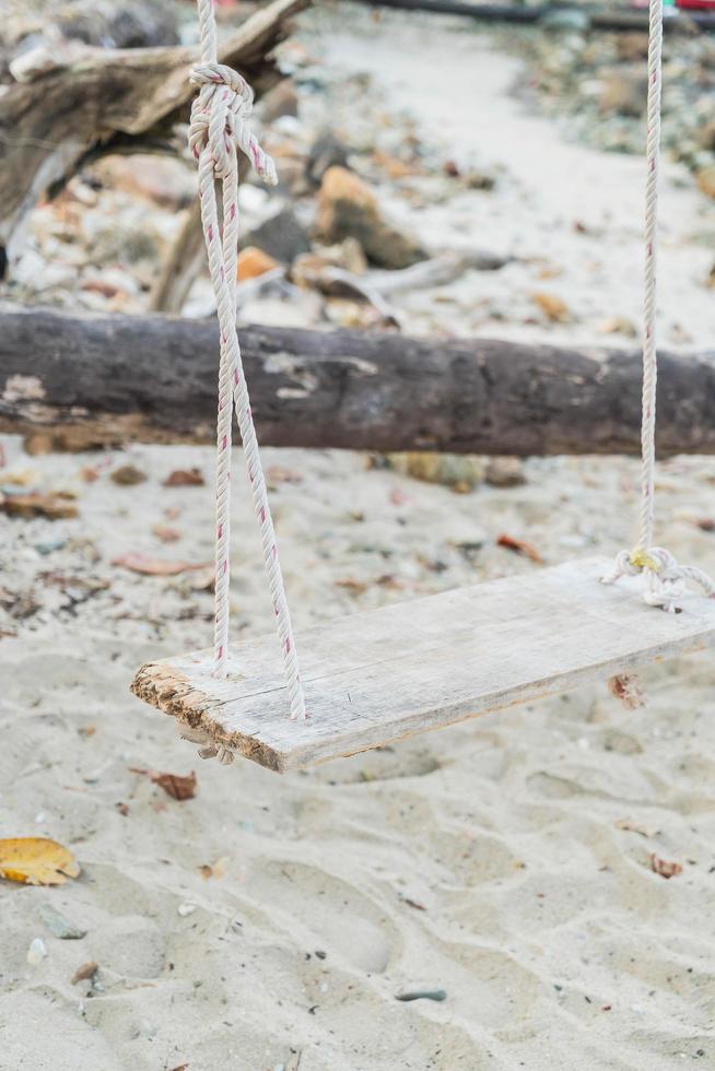 White swing on a beach photo