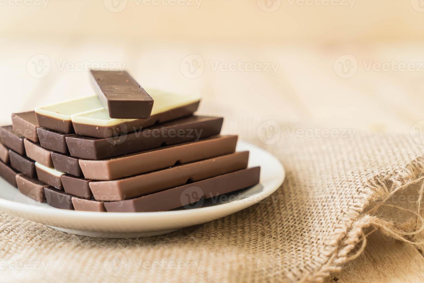 Chocolate bars on wood background photo