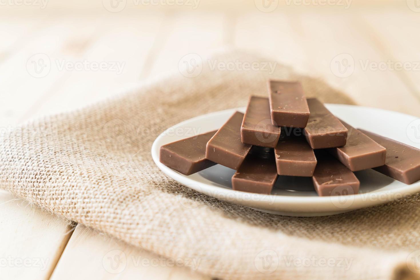 Chocolate bars on wood background photo