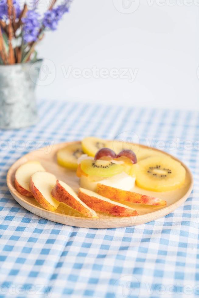 Pudding fruits with kiwi and apple on table photo