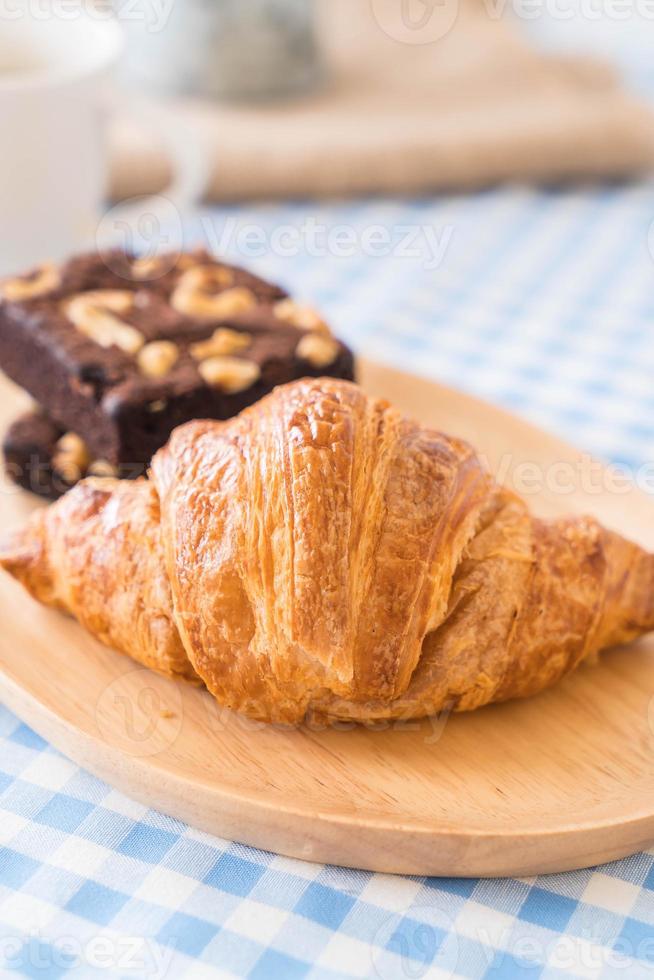 Croissant and brownies on table photo