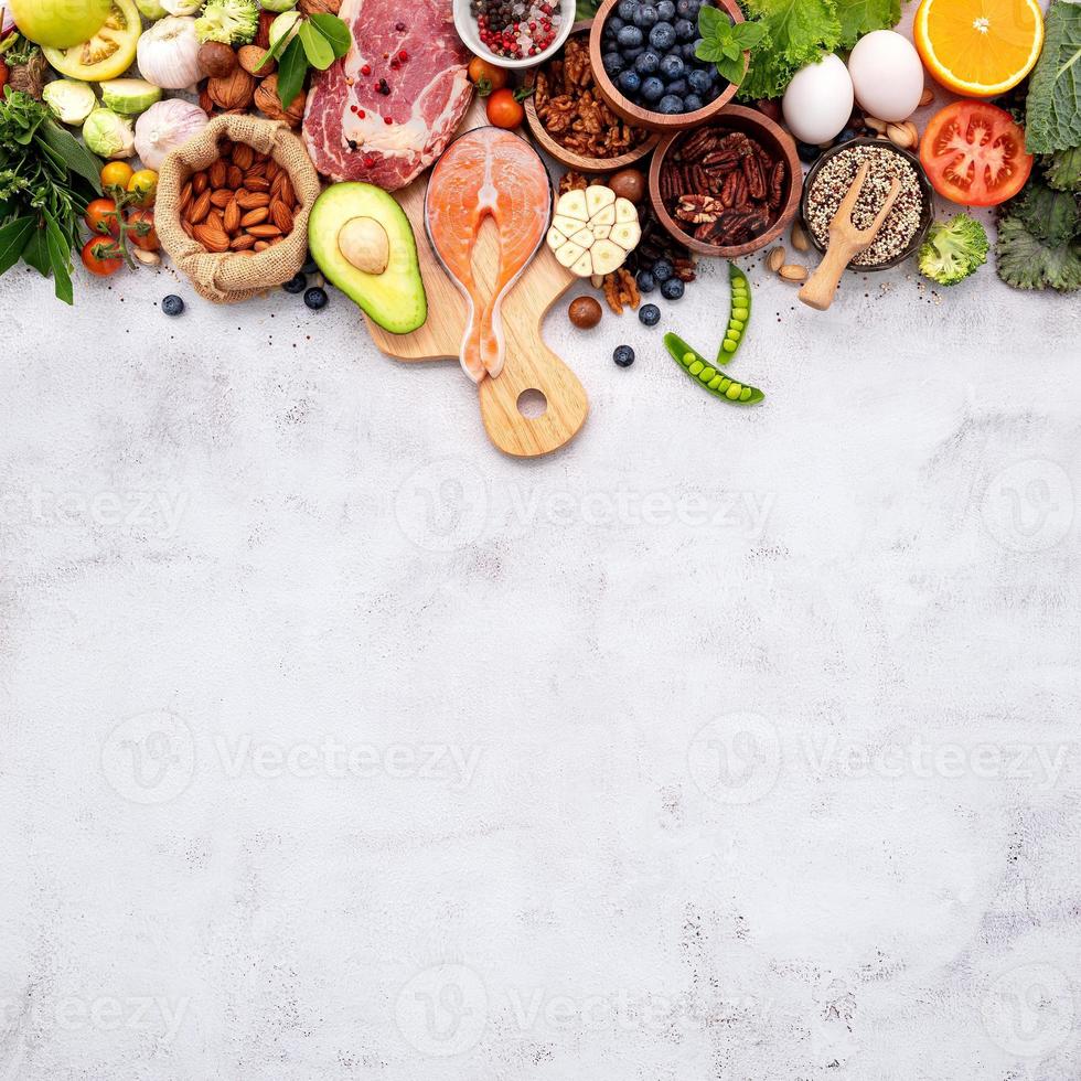 The concept of superfoods set up on white shabby concrete background photo