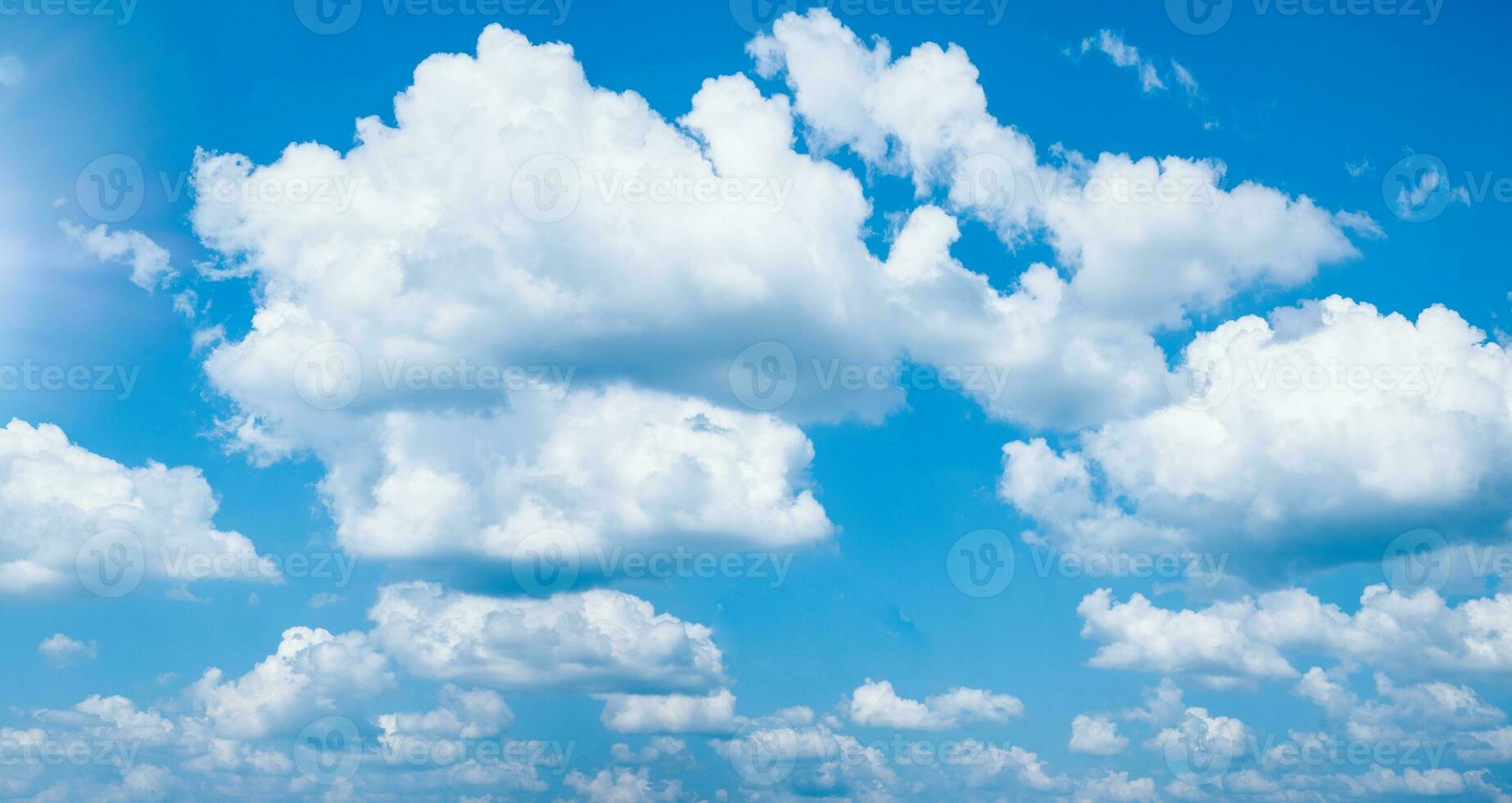 Beautiful blue sky with white clouds and sun photo