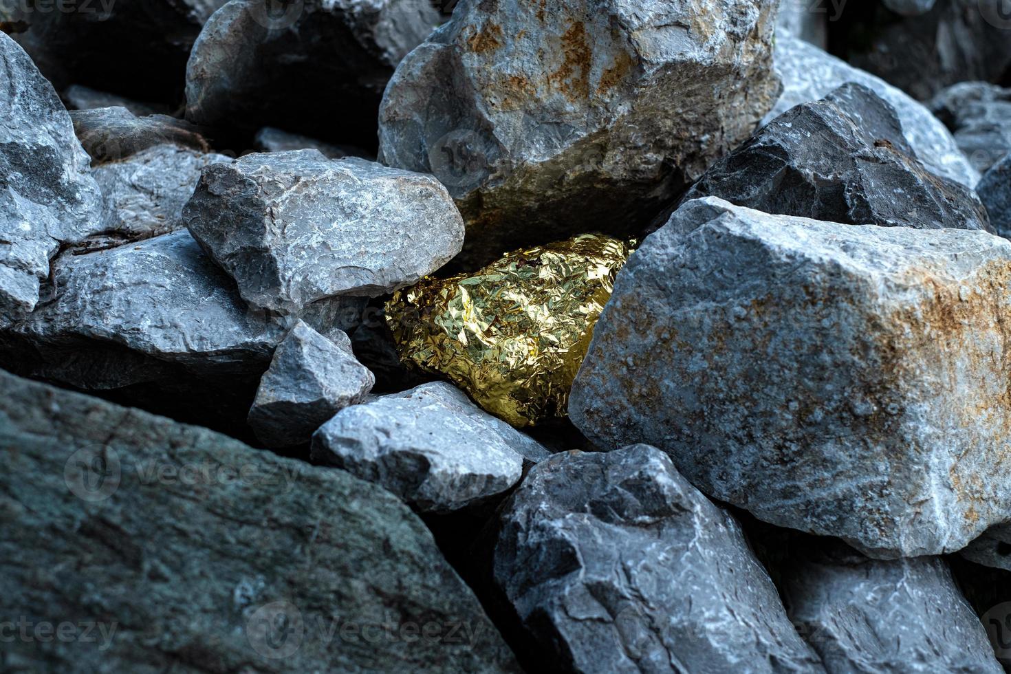 Gold nugget and grey granite stone photo