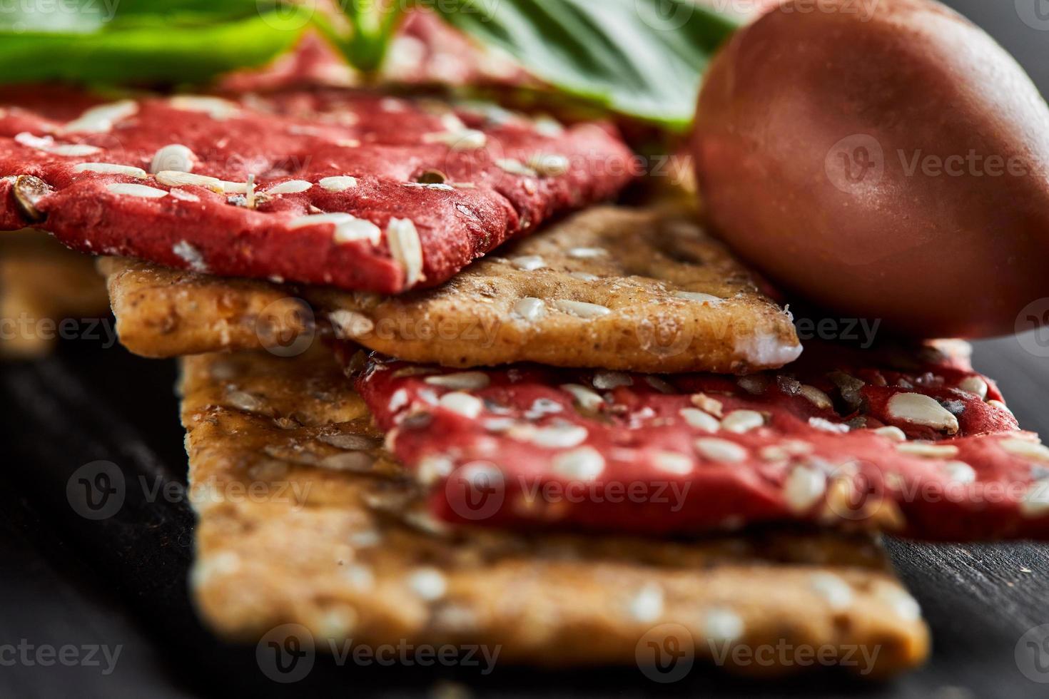 Beetroot and rye flour crackers with vegetables for making snack photo