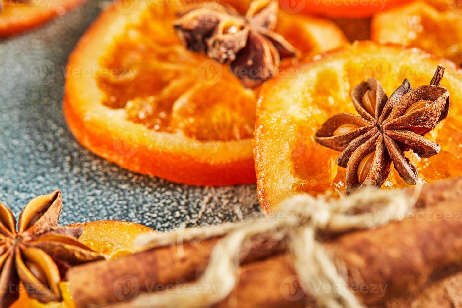 Slices of dried oranges or tangerines with anise and cinnamon photo