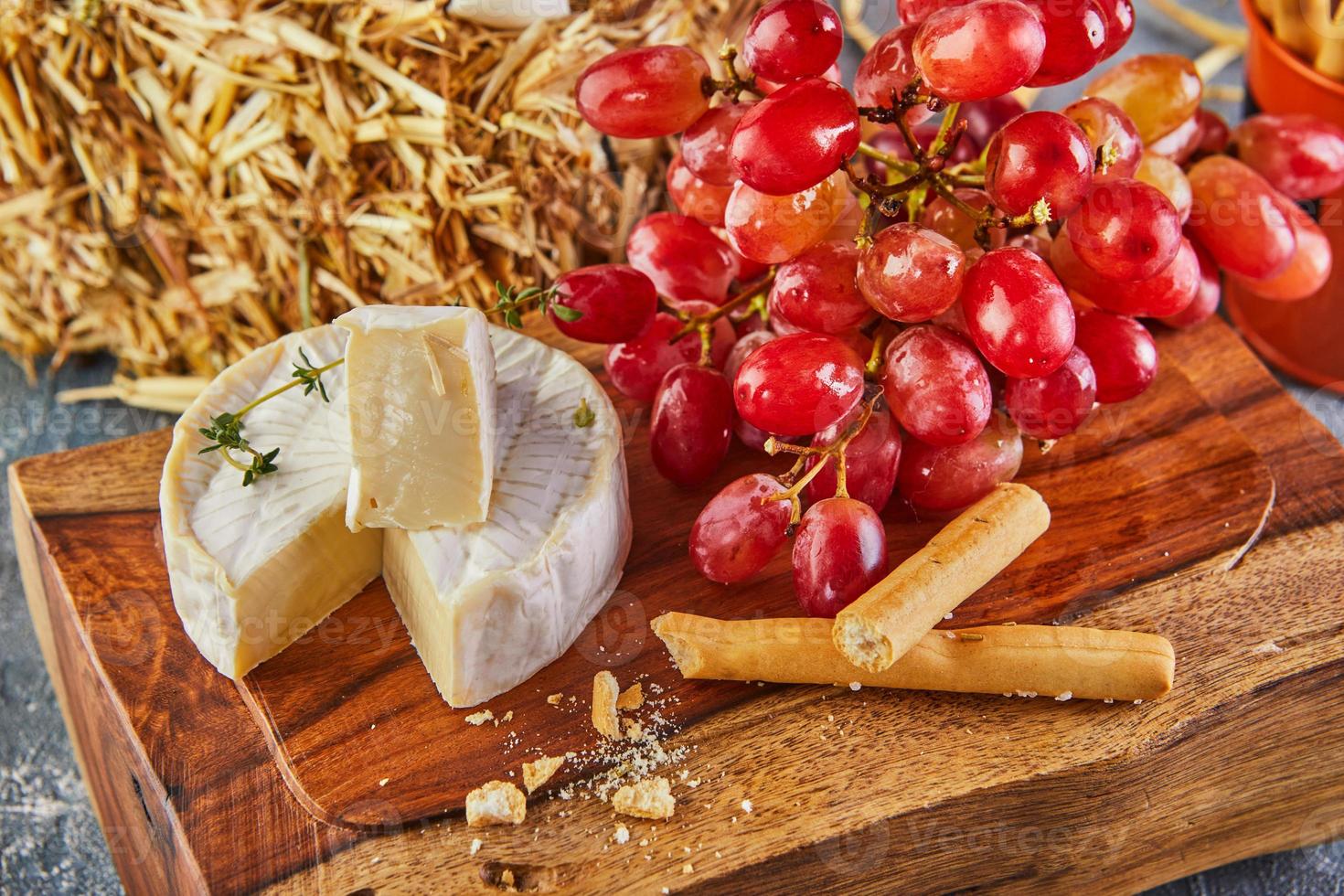 Brie cheese with garlic and grapes photo