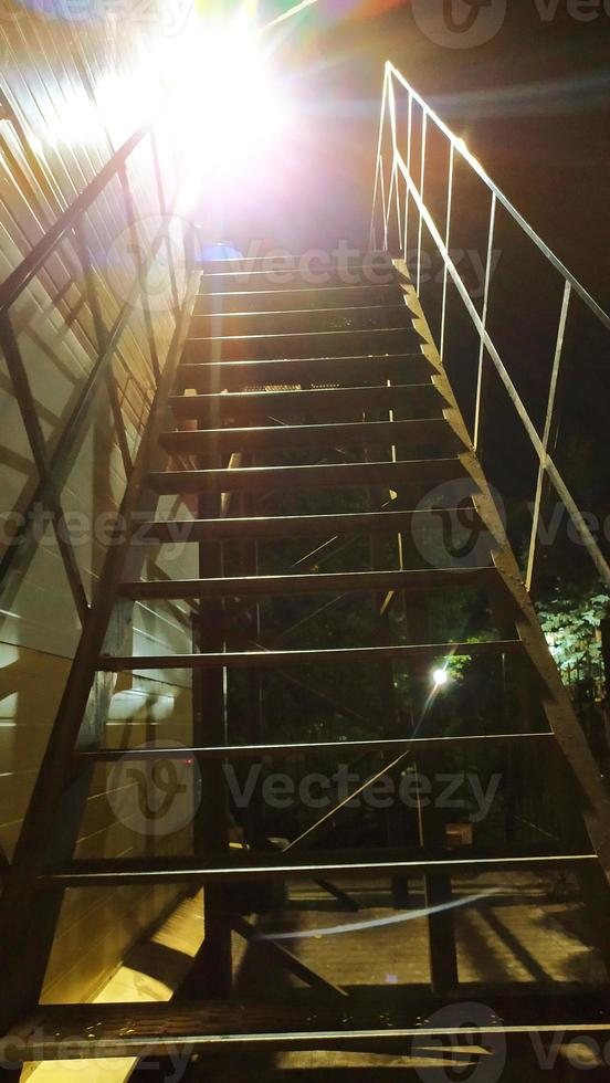 The ladder is metal. The steps go up high photo