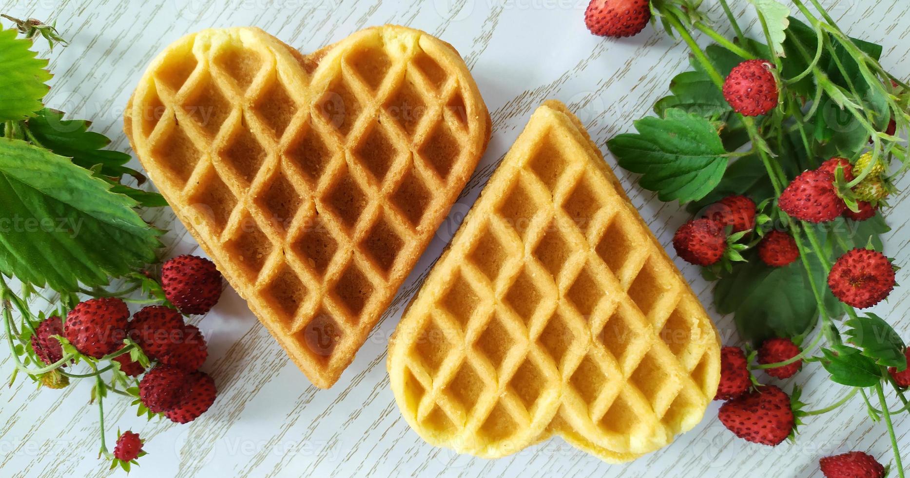 Two hearts Cookies and strawberries. Dessert on a wooden background photo