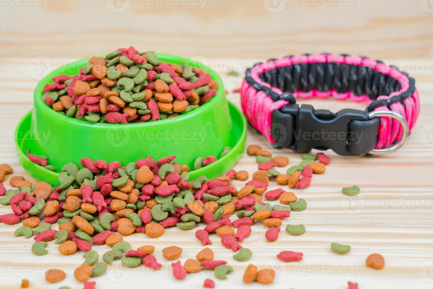 Pet food with dog collar on wooden background photo