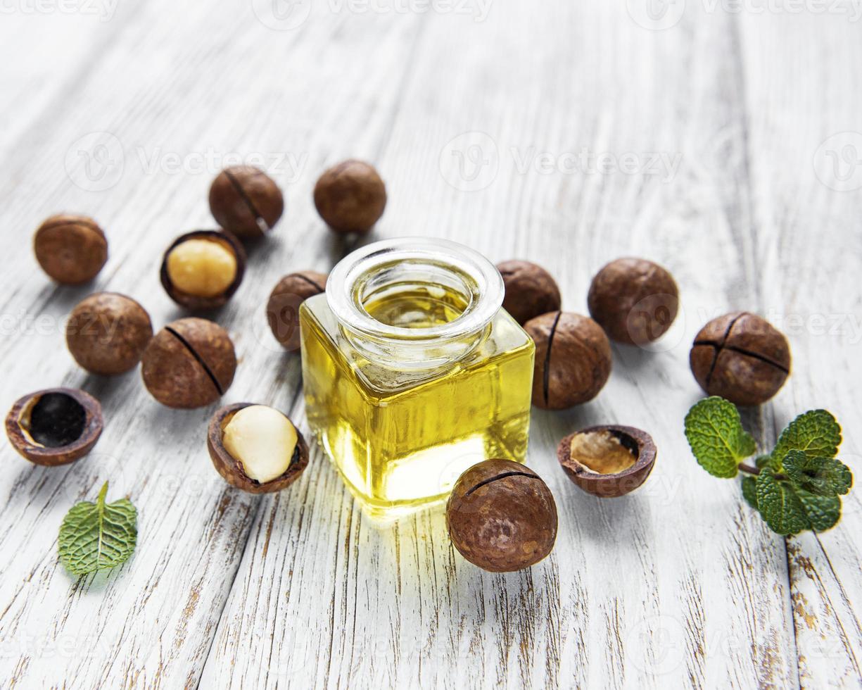 Natural macadamia oil and Macadamia nuts photo