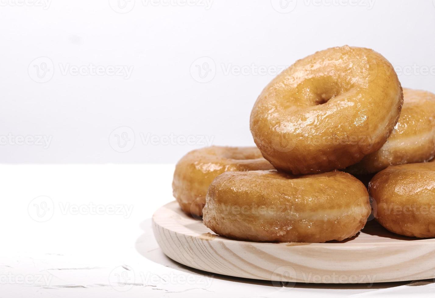 wooden tray with many doughnuts on a white background photo