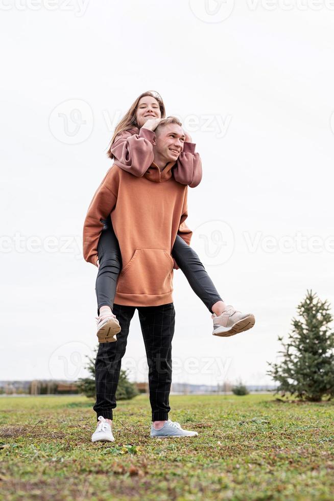 Young loving couple embracing each other outdoors in the park photo