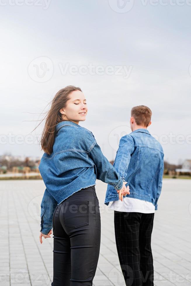 Young loving couple spending time together in the park having fun photo