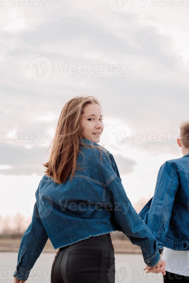 Young loving couple spending time together in the park having fun photo