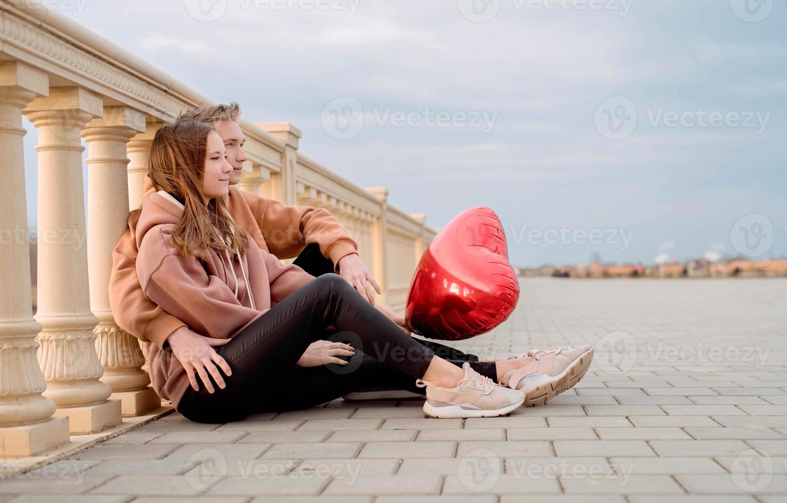 Young couple embracing each other outdoors in the park photo