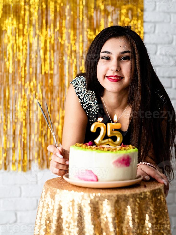 woman  celebrating her birthday ready to blow candles on the cake photo