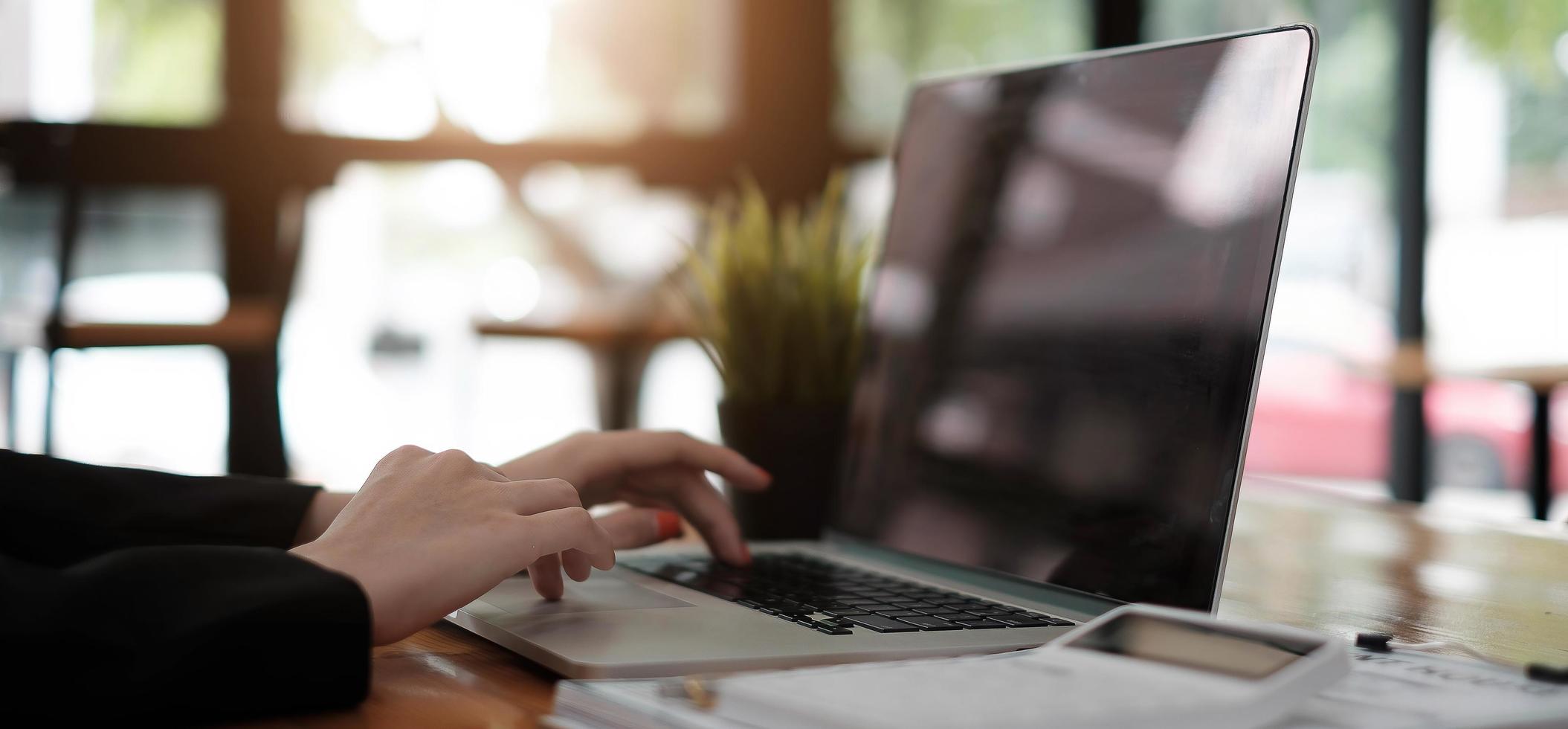 Asian girl working at a office during using laptop computer photo