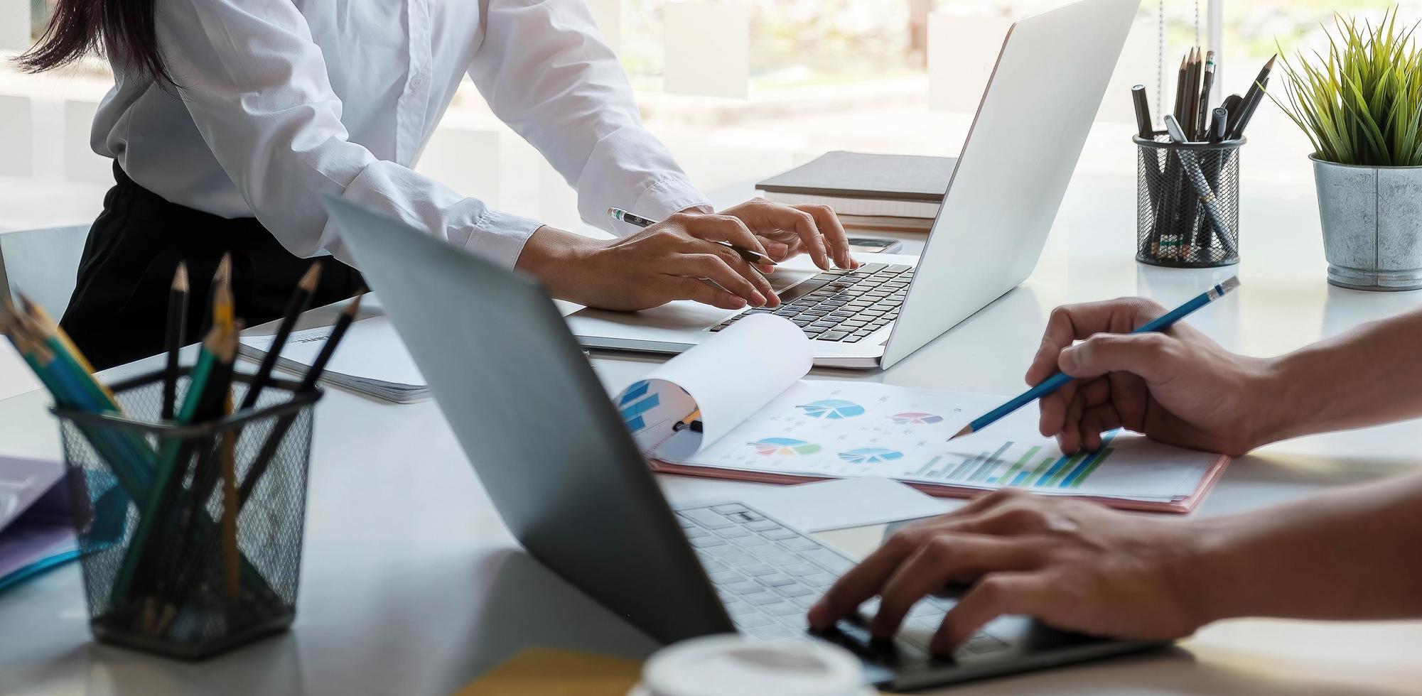 Business team analyzing income charts and graphs photo