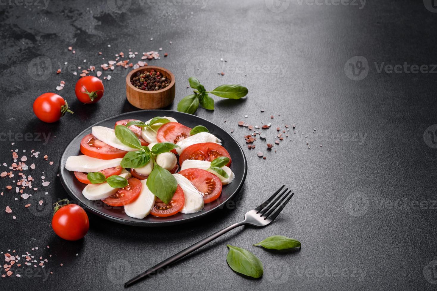 Italian caprese salad with sliced tomatoes, mozzarella cheese photo