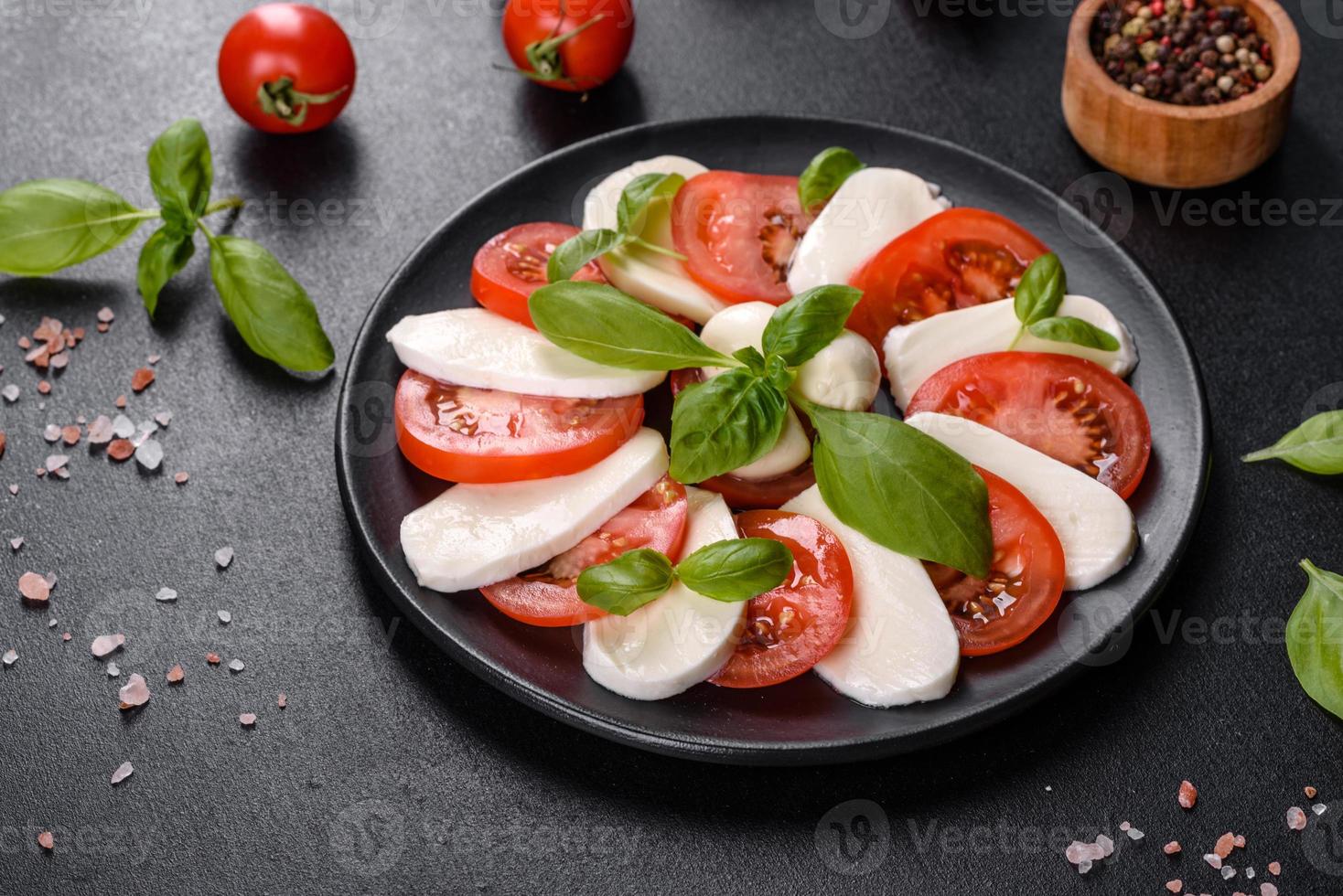 Italian caprese salad with sliced tomatoes, mozzarella cheese photo