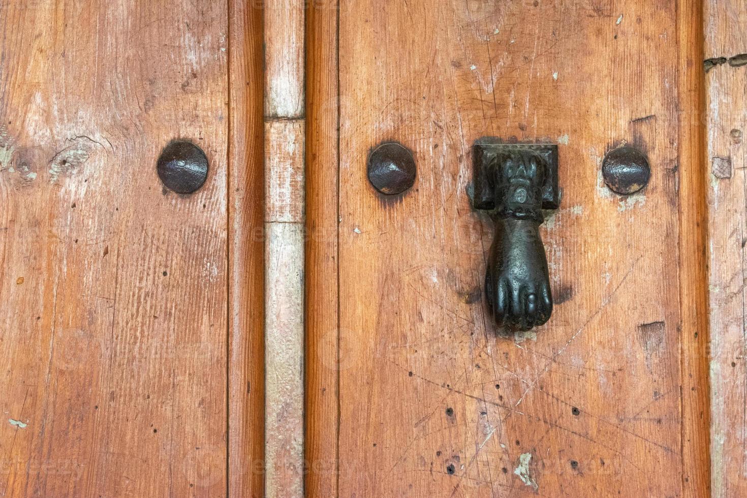 classic antique metal doorknocker with hand shape photo