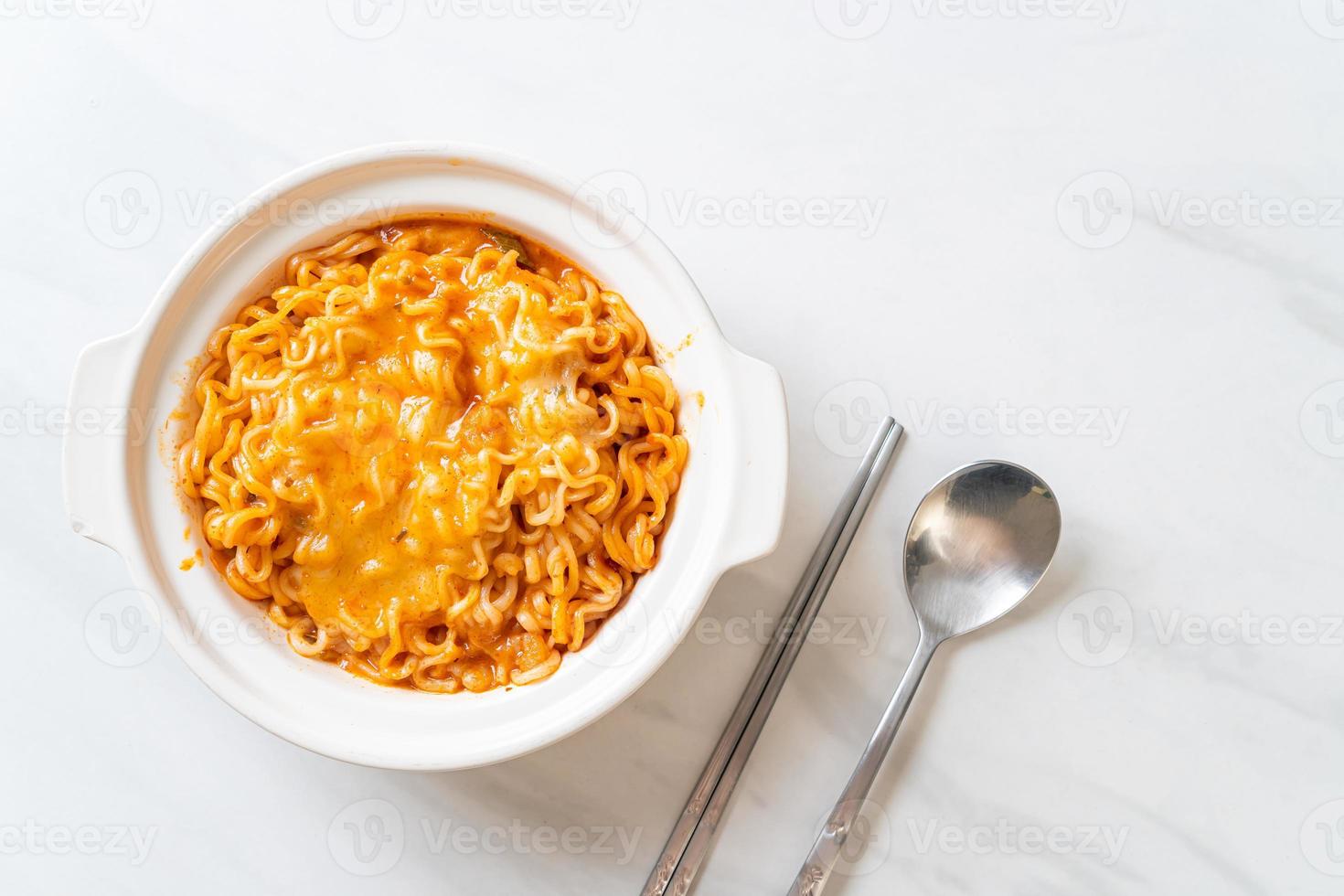 Spicy instant noodle bowl with mozzarella cheese photo