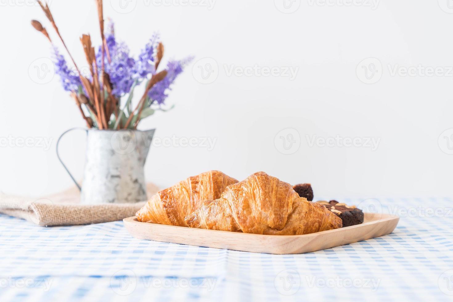 Croissant and brownies on table photo