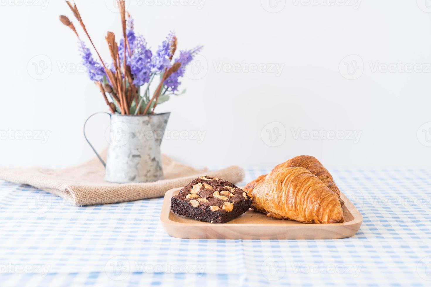 Croissant and brownies on table photo