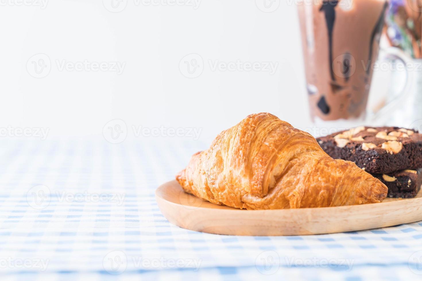 Croissant and brownies on table photo