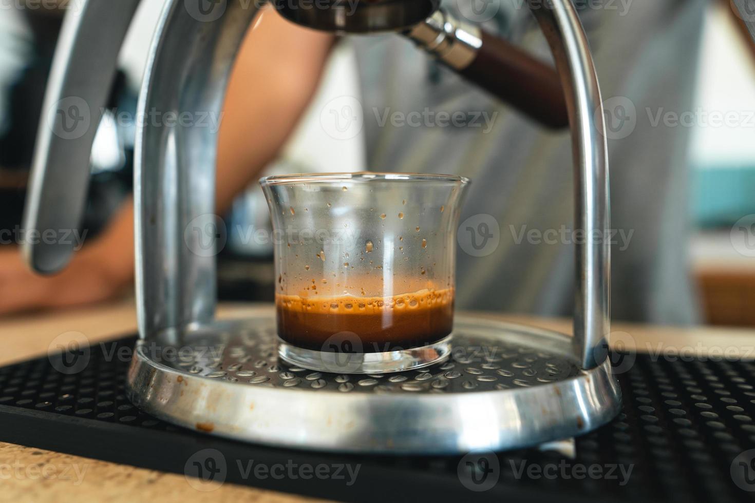 Ecfresso coffee from a press machine into a mug photo