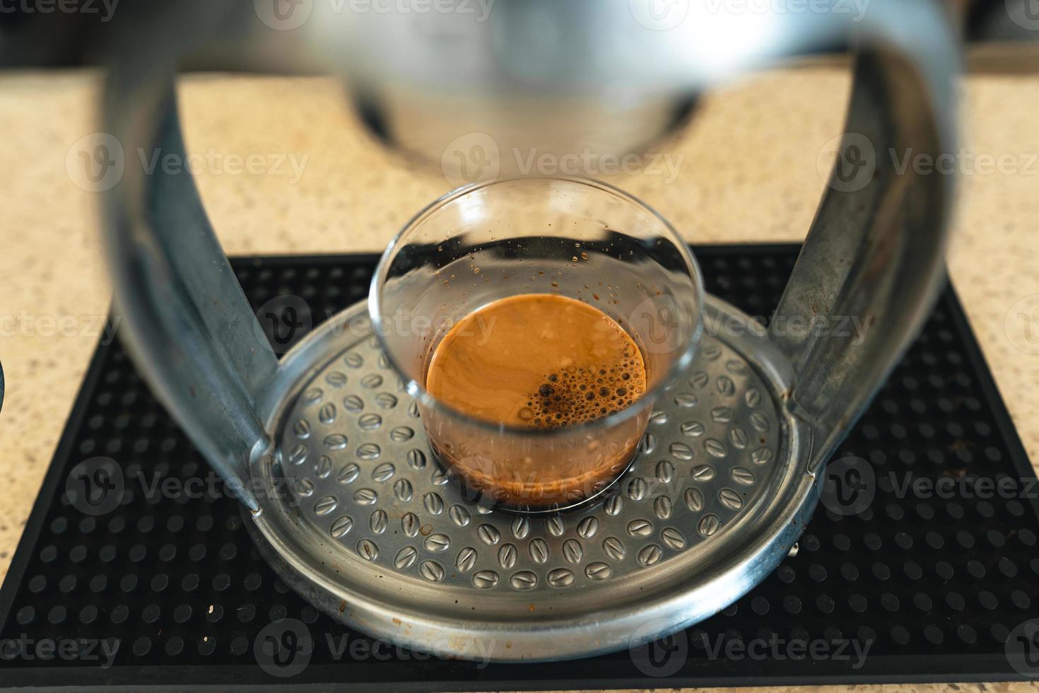 Ecfresso coffee from a press machine into a mug photo